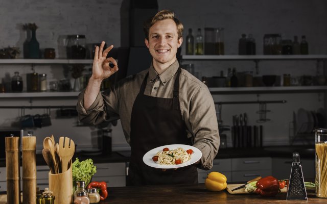 mid-shot-chef-holding-plate-with-pasta-and-making-ok-sign.jpg